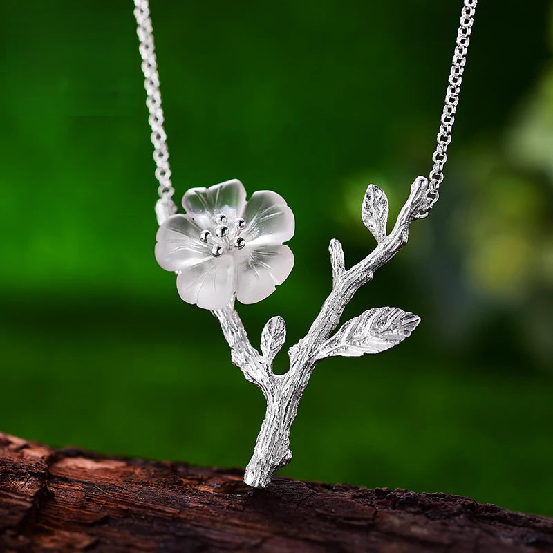 Women's Crystal Flower Pendant Necklace 295 with an elegant silver branch design, featuring a delicate translucent flower inspired by nature jewelry.