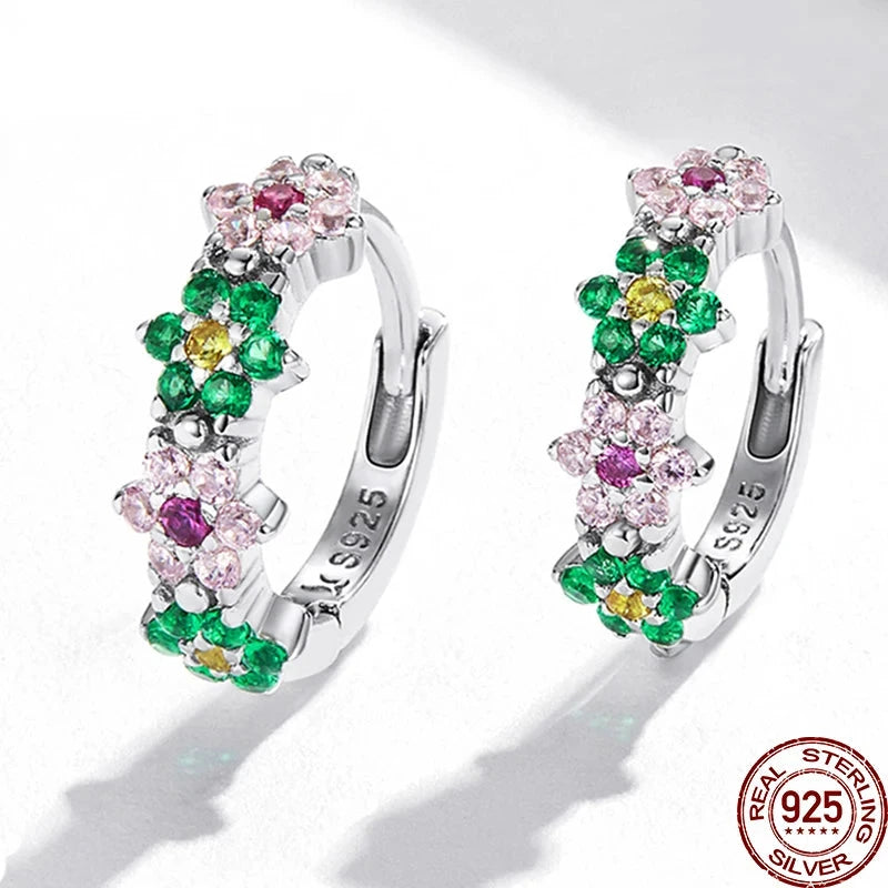 A pair of sterling silver earrings featuring a floral pattern with multicolored gemstones.