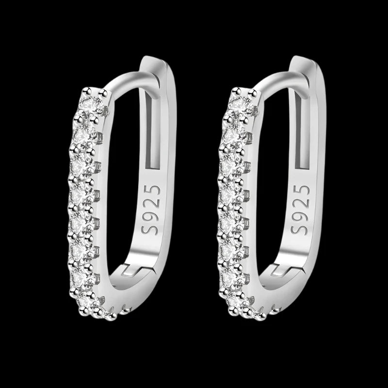 A pair of sterling silver hoop earrings encrusted with cubic zirconia decorations.