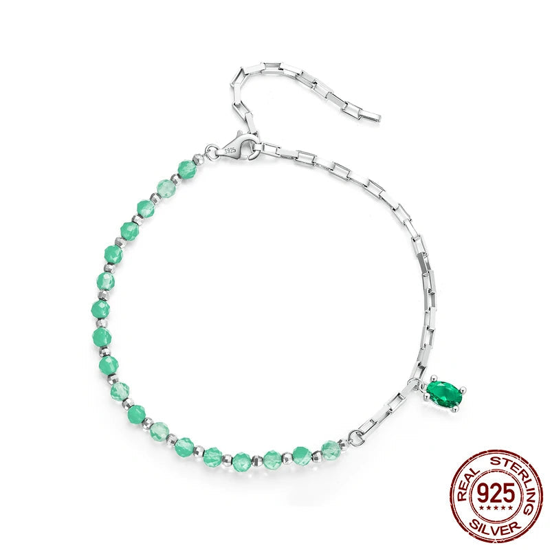A sterling silver bracelet with green beads, featuring a clasp closure.