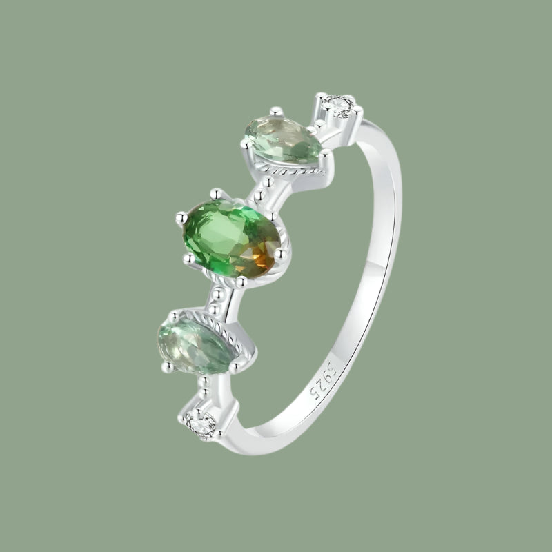 A 925 sterling silver ring with a gradient glass design, featuring green and orange colors, set with three zircon stones.