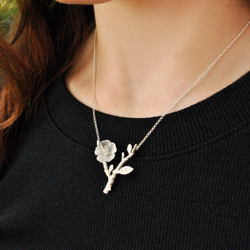 Women's Crystal Flower Pendant Necklace 295 with an elegant silver branch design, featuring a delicate translucent flower inspired by nature jewelry.