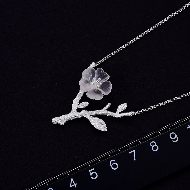 Women's Crystal Flower Pendant Necklace 295 with an elegant silver branch design, featuring a delicate translucent flower inspired by nature jewelry.