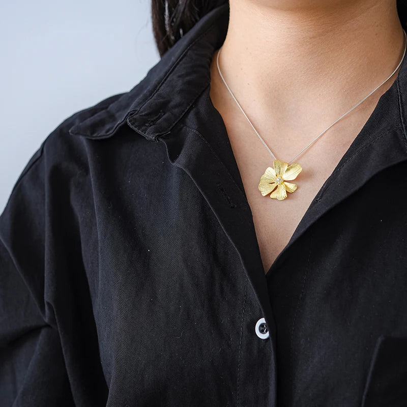 Luxury floral jewelry pendant necklace for women with sparkling zircon crystals and 18K gold plated flower design on a 925 sterling silver chain
