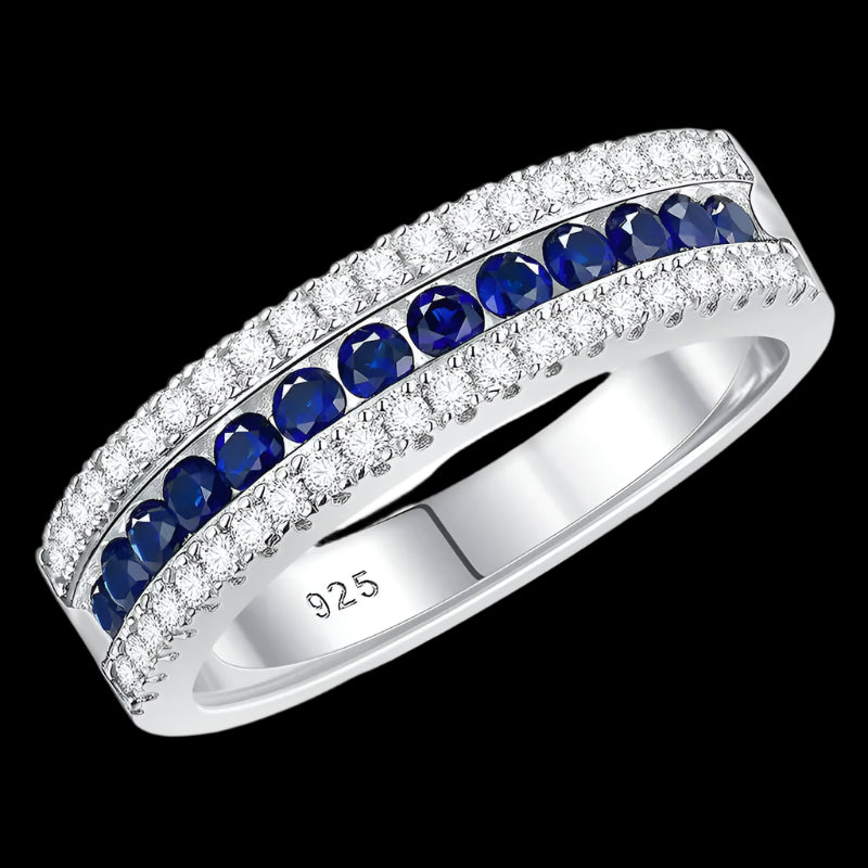 Silver ring with blue gemstones and 'Real Sterling 925' stamp on a white background